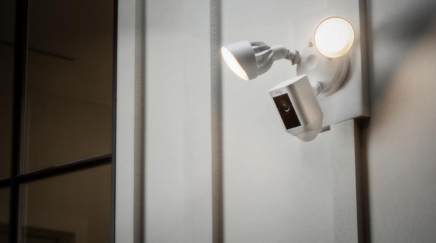 Ring floodlight camera outside home with two lights on