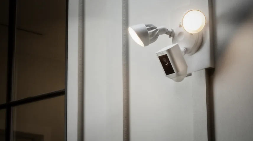 Ring floodlight camera outside home with two lights on