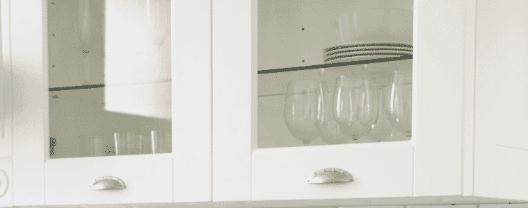 A closeup of a Hamptons style white kitchen cabinet