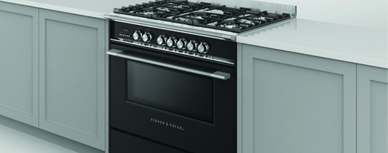 A black freestanding cooker in a white kitchen