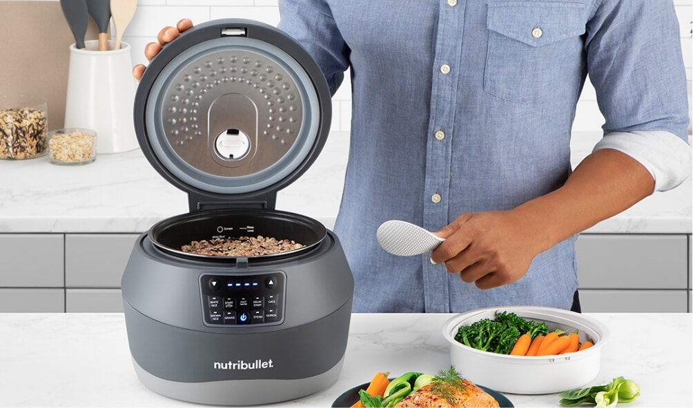 Man cooking rice and fish with his Grain Cooker from nutribullet
