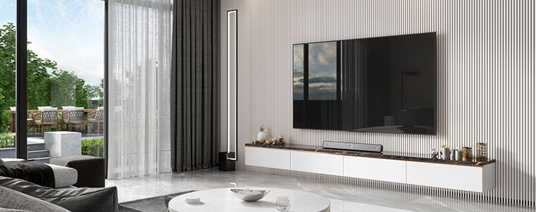 Modern living room with mounted big screen TV round marble coffee table and garden view