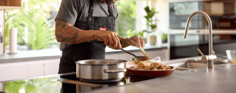 a man cooking dinner on his Mele induction cooktop 
