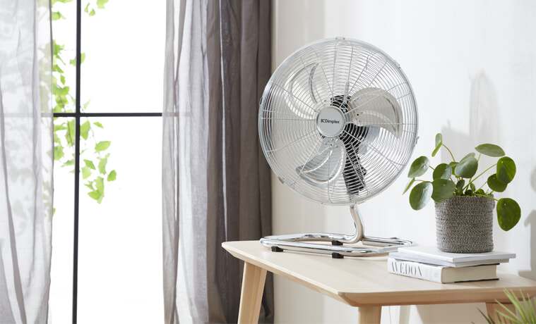 A Dimplex fan sits on a desk in a bright and airy room