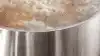 Gas cooktop with a pot of boiling water.