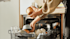 Woman stacking her Haier Dishwasher at home.