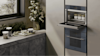 Close up of two smeg ovens on a wall.