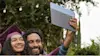 Father and daughter using Chromebook to take a selfie at Graduation. 