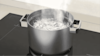 Close-up image of a pot boiling on a Westinghouse induction cooktop.