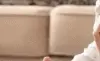 Young parents in the living room with their baby and Christmas gift