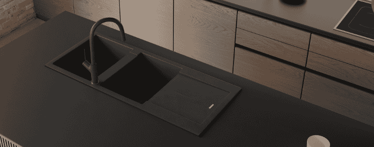 A black sink matches the black kitchen benchtop