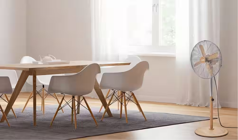 Lifestyle image of an ewt pedestal fan in a dining room.