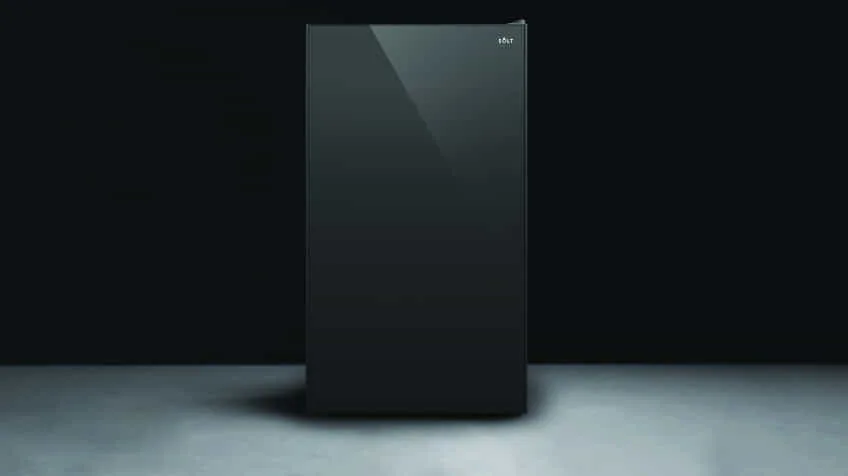 black Solt fridge on grey floor with black background