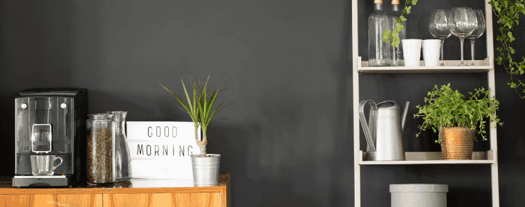 Side area of dining area showing coffee machine cups and plants