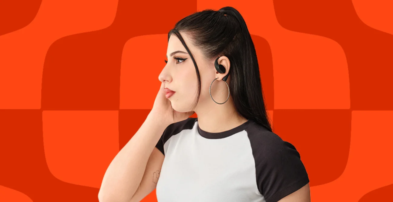 woman holds JBL true wireless earbudss