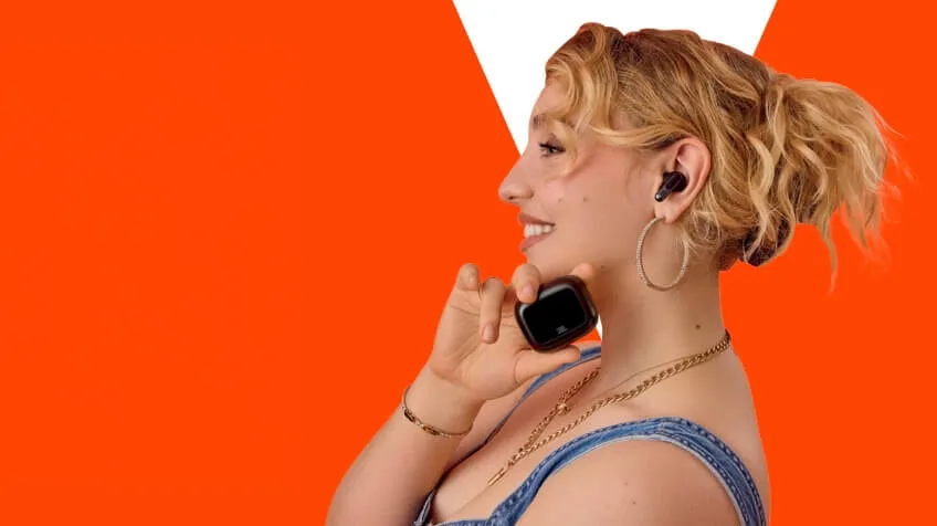 woman holds JBL true wireless earbudss
