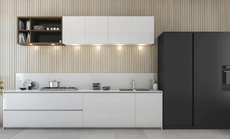 A white modern kitchen with a black fridge