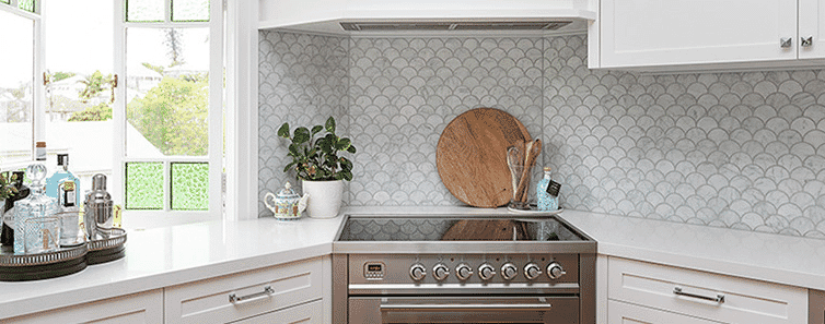 A modern kitchen splashback and stainless steel oven