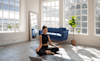 A woman meditates in her home