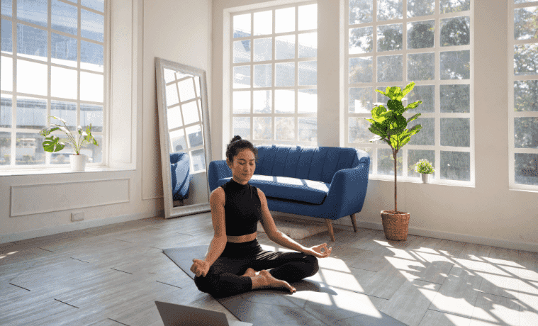 A woman meditates in her home