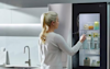 Image of hand knocking on the front of an LG InstaView Fridge door.