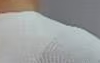 Image of hand knocking on the front of an LG InstaView Fridge door.