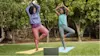 Two women practising yoga outside with their Lenovo Chromebook.
