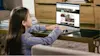 Girl using her Chromebook laptop in a living room.
