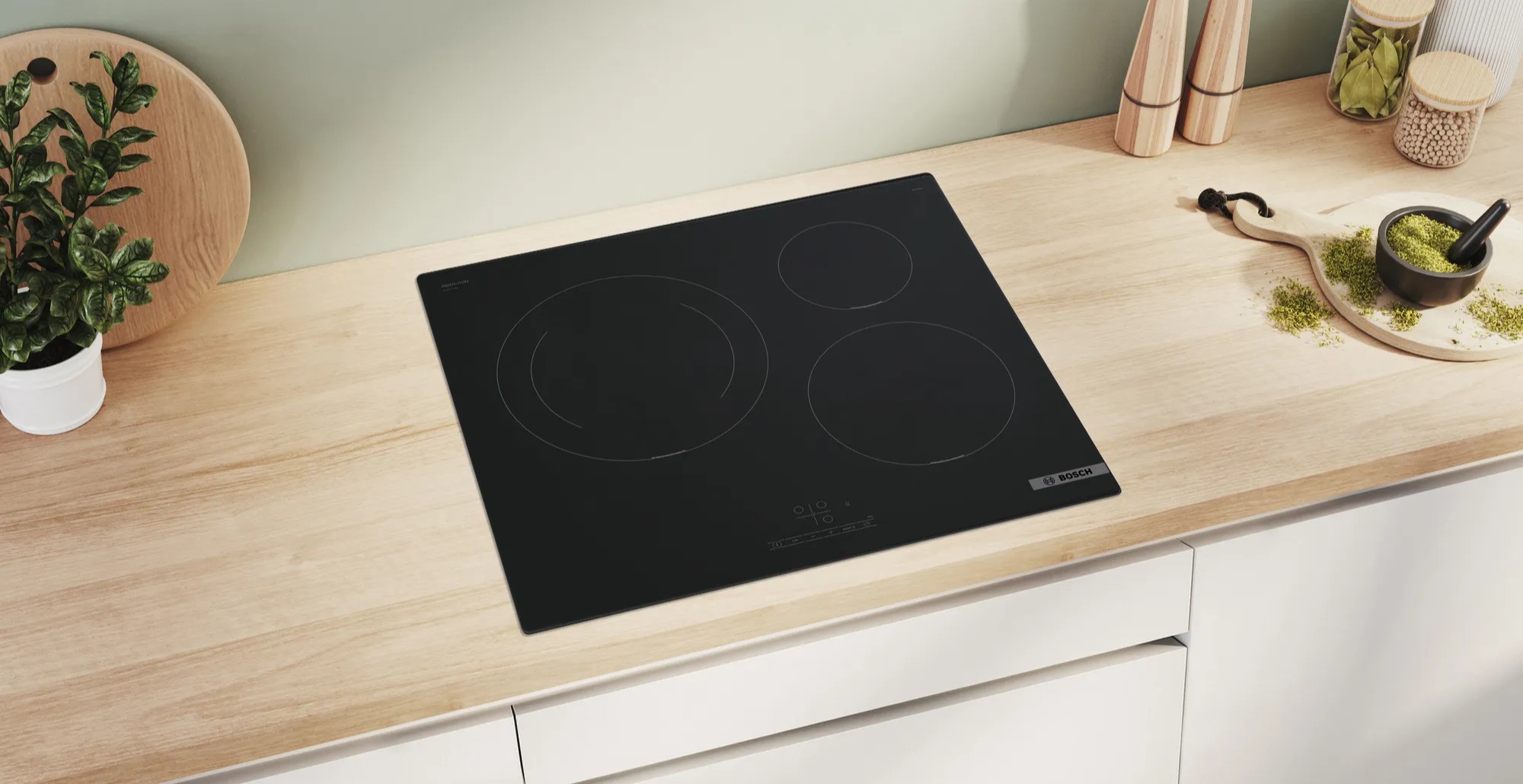 Bosch cooktop on wooden countertop.