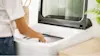Woman loading her Haier top load washing machine.