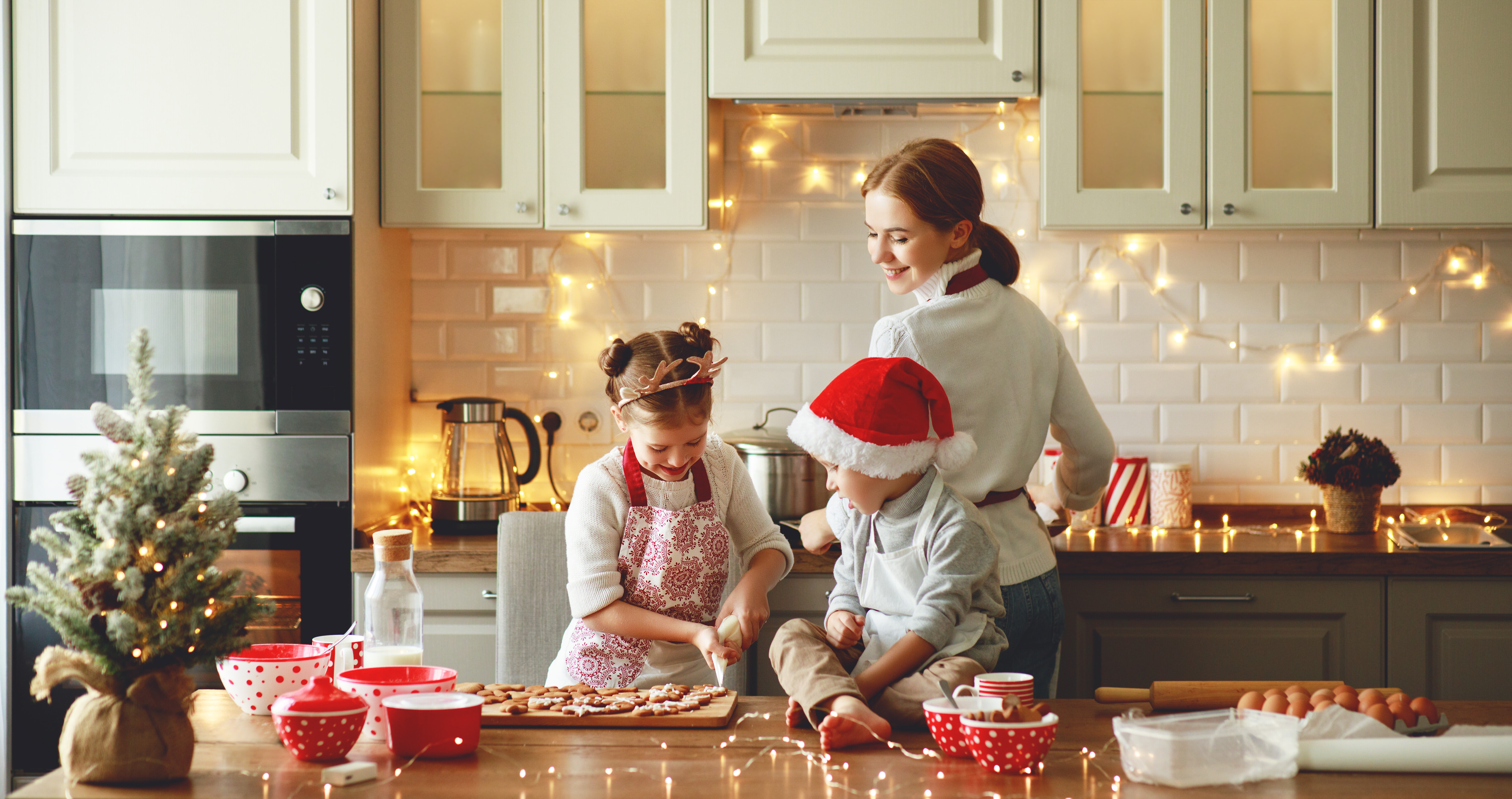 A mum in her kitchen cooking with her kids