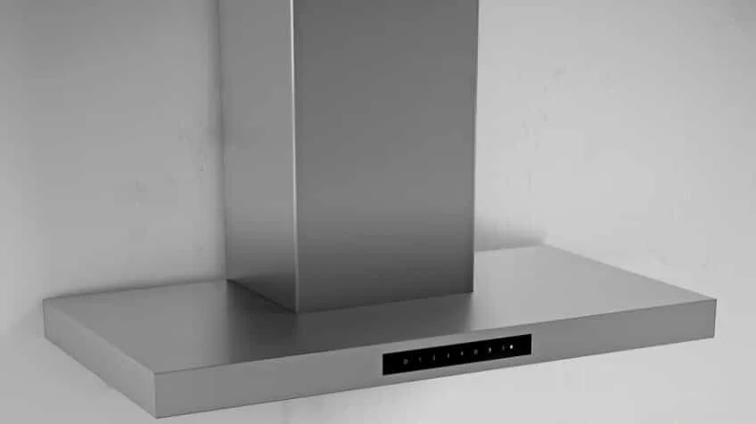 A silver Smeg rangehood against a white wall