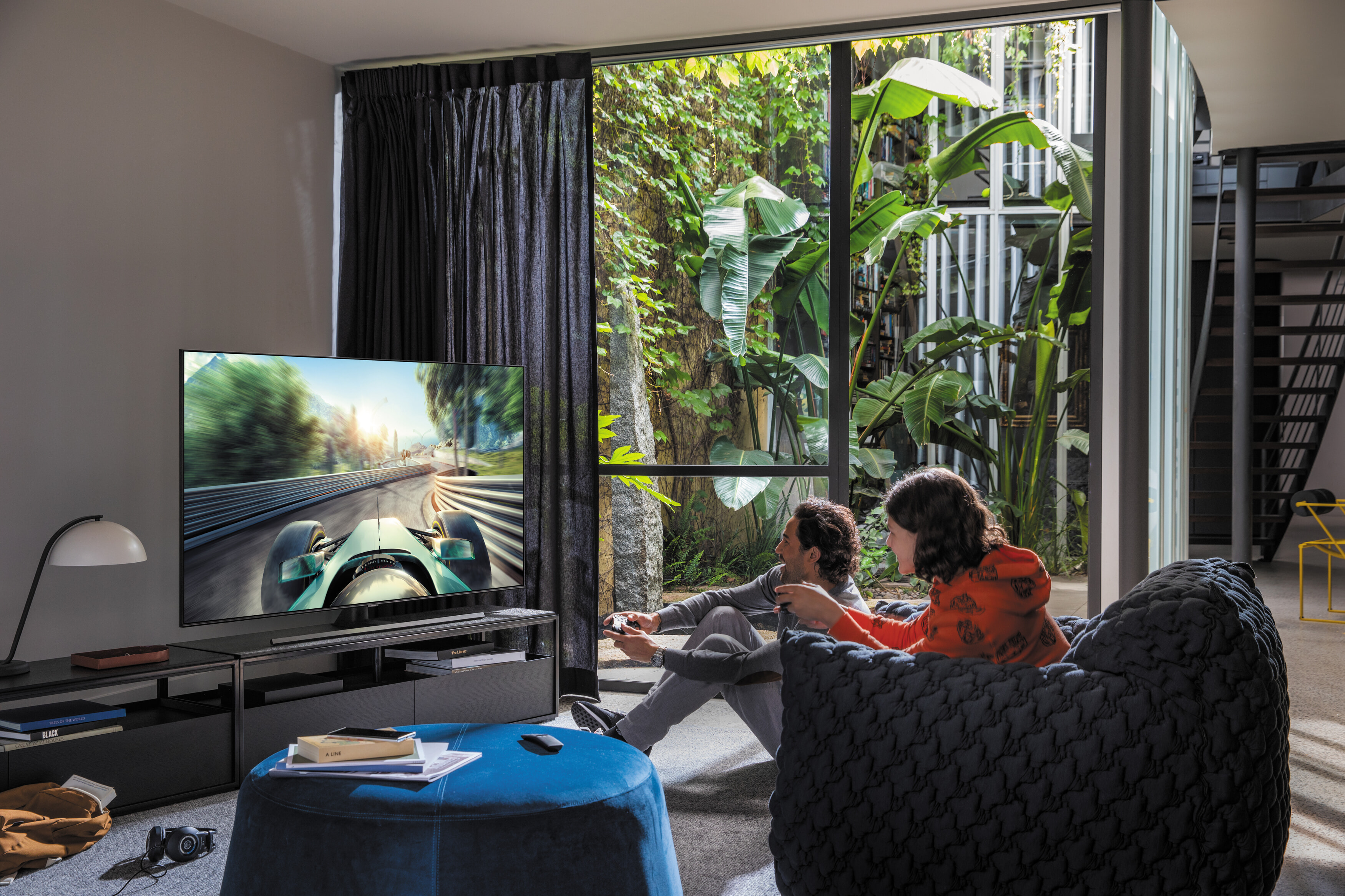 People playing video games on their new TV in a modern living area