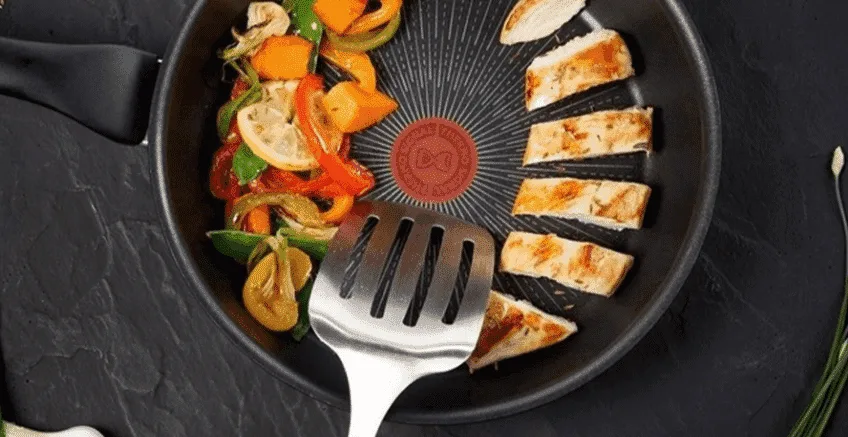 A Tefal Frying Pan being used to cook chicken and vegetables