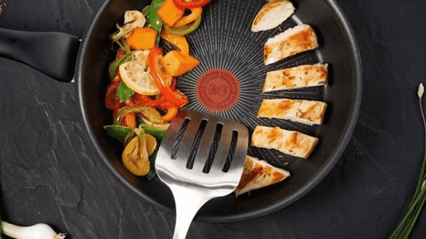 A Tefal Frying Pan being used to cook chicken and vegetables