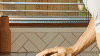 Man stacking his Haier Built-In Dishwasher.
