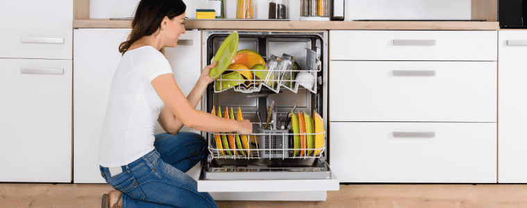 A woman unloading a dishwasher