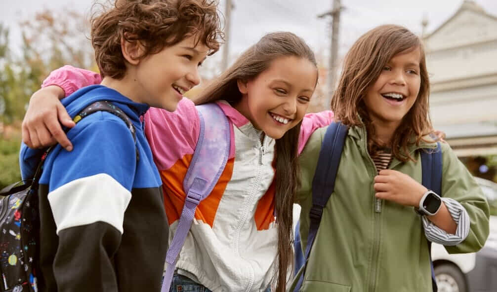 Three children walking together smiling wearing their Spacetalk Adventurer 2 smartwatch