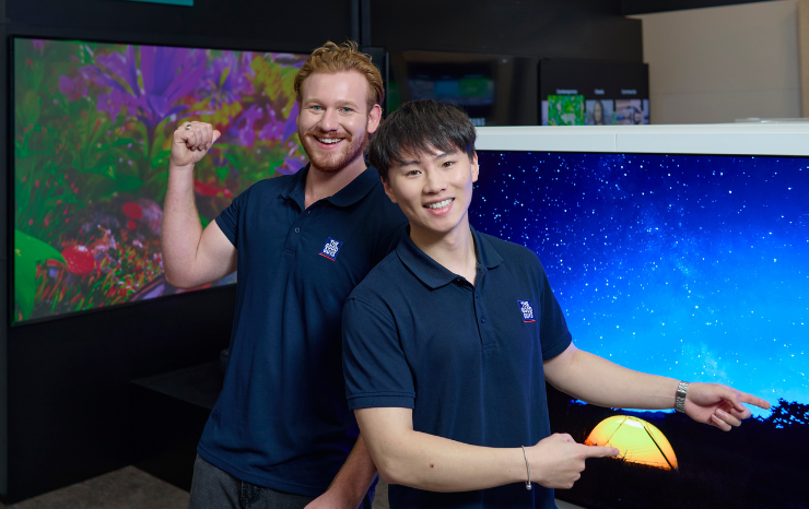 The Good Guys staff members next to TVs
