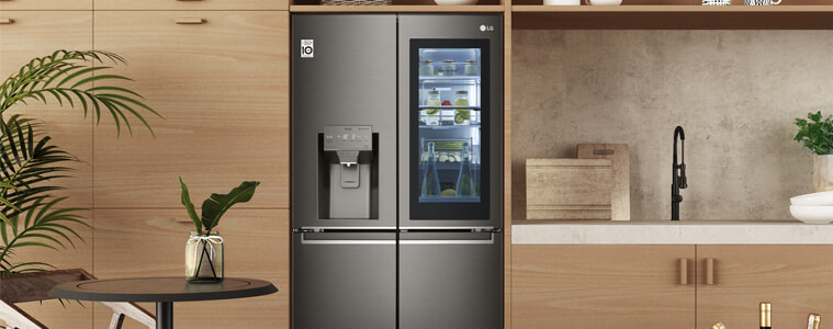 A smart fridge in a warmtoned wooden kitchen