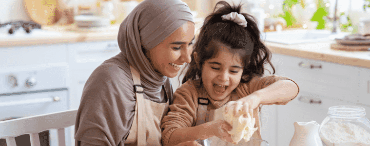A mother and daughter cooking together