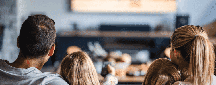 a family sitting together watching a movie