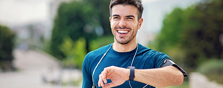 Man checks his smartwatch after a run