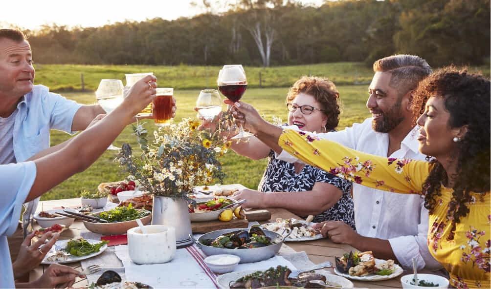 Participants in BeefEaters cooking competition enjoying their meals outside in summer