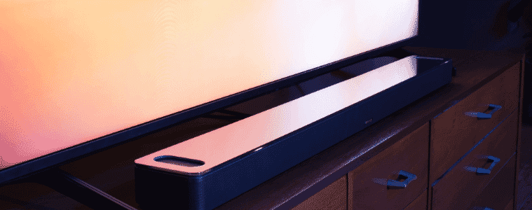 Smart soundbar sitting in front of a big screen tv to create the ultimate home theatre setup