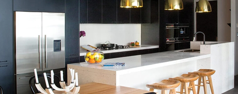 A modern kitchen with black cabinets and white countertops