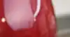 A red kettle and toaster sitting on a kitchen bench