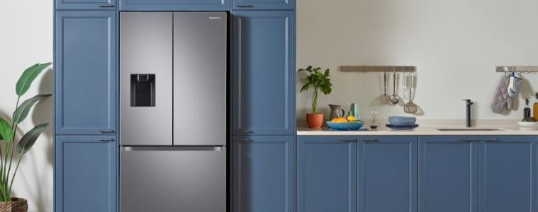 A chrome fridge in a blue straight line kitchen