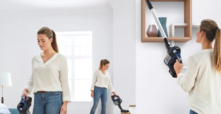 Woman vacuuming all around her home with a Bosch vacuum cleaner.