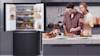 Lifestyle image of an LG Slim French Door Fridge with a family cooking in a modern kitchen